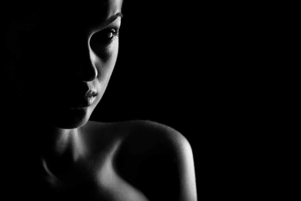 A face half-lit against darkness
